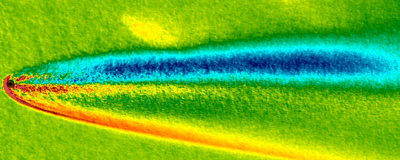 Example of computation done at HPC2N.  The interaction between the solar wind and Mars. Shown is the magnetic field strength, with Mars in black to the left. (Graphic: IRF)